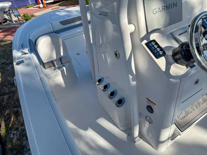 Hybrid Performance Yacht Photos Pics 2025 Caymas 24 HB boat interior with Garmin system and steering wheel.