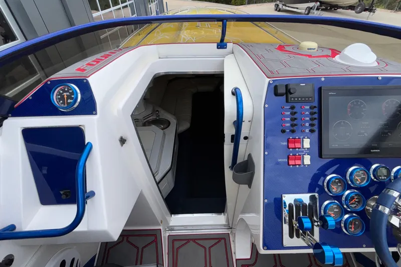  Yacht Photos Pics 2007 Fountain 42 Lightning boat cockpit with control panel and cabin entrance.