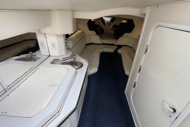  Yacht Photos Pics Interior of 2007 Fountain 42 Lightning boat with white seating and kitchenette.