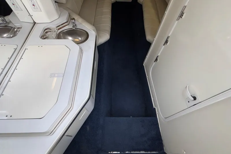  Yacht Photos Pics Interior of a 2007 Fountain 42 Lightning boat with white cabinetry and seating.