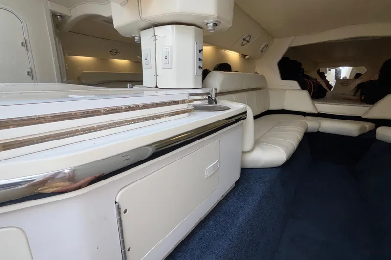  Yacht Photos Pics Interior of 2007 Fountain 42 Lightning boat with white seating and blue carpet.