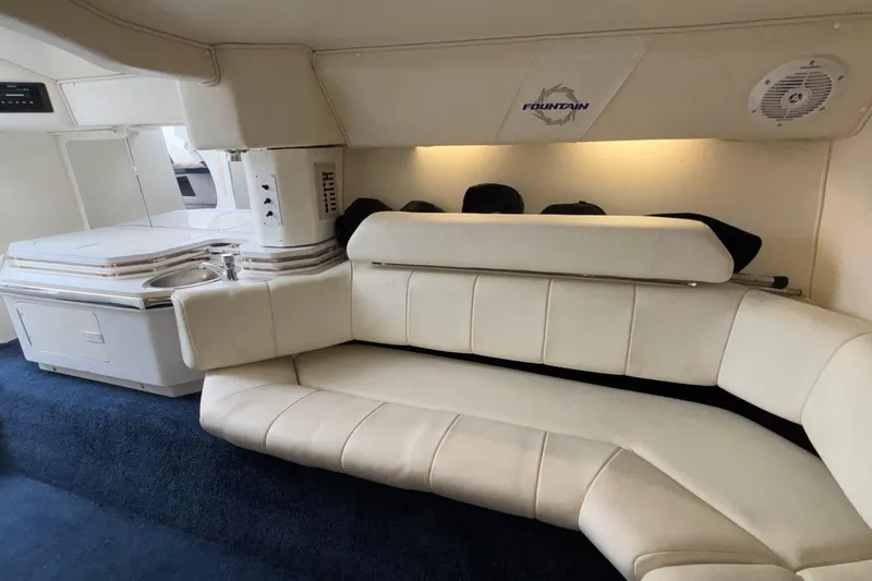  Yacht Photos Pics Interior of 2007 Fountain 42 Lightning boat with white seating and kitchenette.