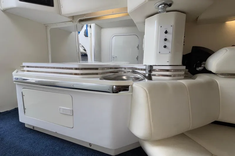  Yacht Photos Pics 2007 Fountain 42 Lightning interior with kitchenette, sink, and seating.