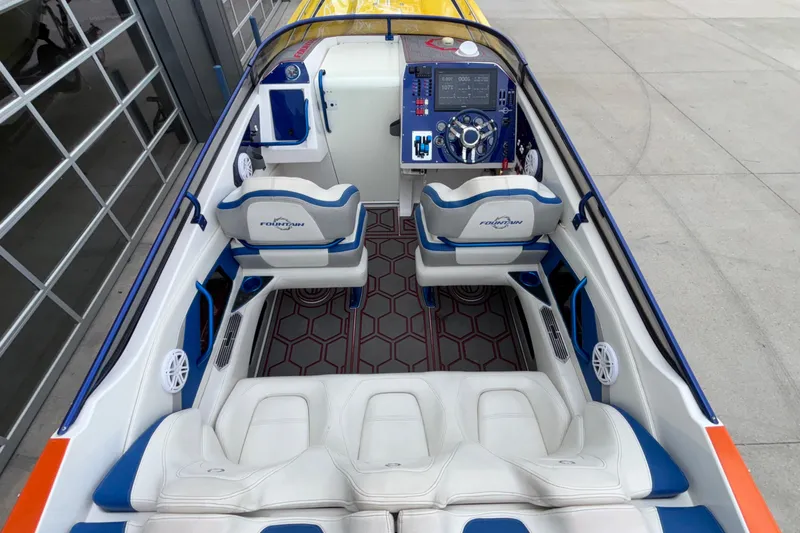  Yacht Photos Pics 2007 Fountain 42 Lightning boat interior with white and blue seating, modern dashboard.