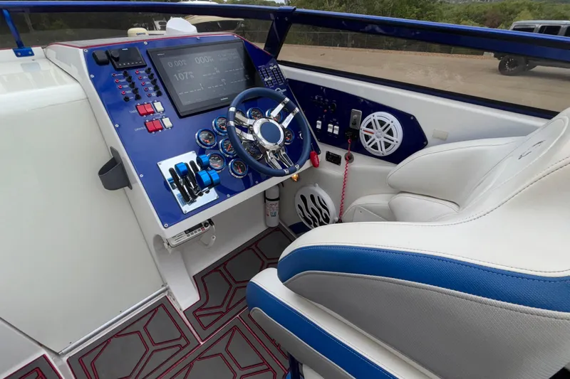  Yacht Photos Pics 2007 Fountain 42 Lightning boat cockpit with steering wheel and control panel.