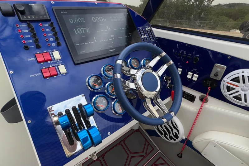  Yacht Photos Pics Control panel of a 2007 Fountain 42 Lightning boat with steering wheel and gauges.