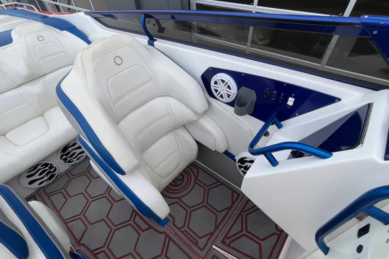  Yacht Photos Pics 2007 Fountain 42 Lightning boat interior with white and blue seating, speaker, and controls.