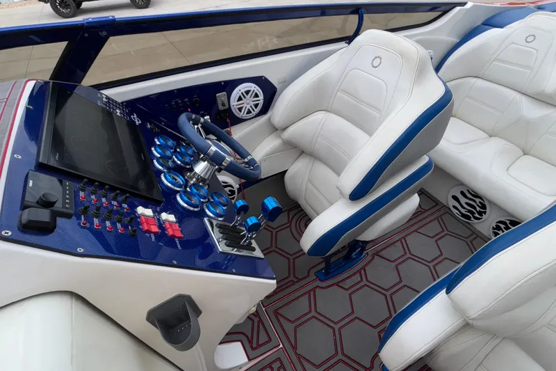  Yacht Photos Pics Interior of 2007 Fountain 42 Lightning boat with white and blue seating, modern dashboard.