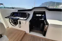 Helm of 2019 Custom Line 106 yacht with modern controls and wooden deck.