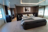 Luxurious bedroom interior on a 2019 Custom Line 106 yacht, featuring modern decor and ambient lighting.