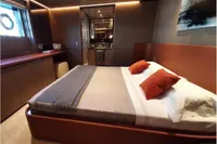 Luxurious bedroom interior on 2019 Custom Line 106 yacht with modern decor and ambient lighting.