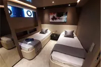 Luxurious twin cabin interior on a 2019 Custom Line 106 yacht, featuring modern decor.