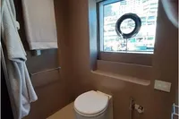 Luxurious yacht bathroom with modern fixtures, window view, and elegant design, Custom Line 106, 2019.