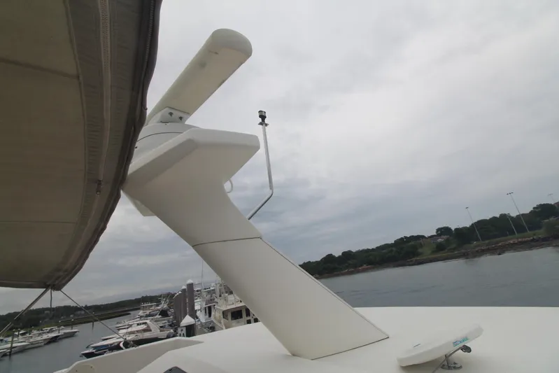 Jet Lag Yacht Photos Pics 2000 Silverton 392 Motor Yacht radar equipment with marina background.