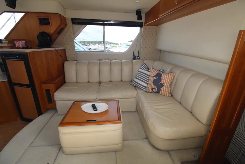 Jet Lag Yacht Photos Pics Interior of 2000 Silverton 392 Motor Yacht with beige seating and nautical-themed decor.