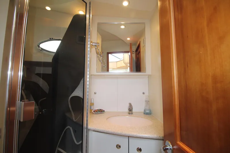 Jet Lag Yacht Photos Pics Bathroom interior of 2000 Silverton 392 Motor Yacht with shower and vanity.