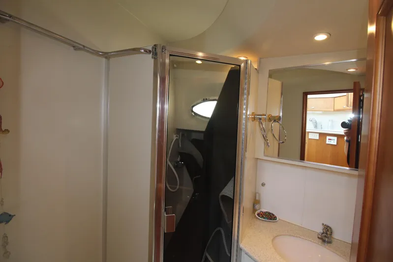Jet Lag Yacht Photos Pics Bathroom interior of 2000 Silverton 392 Motor Yacht with shower and sink.