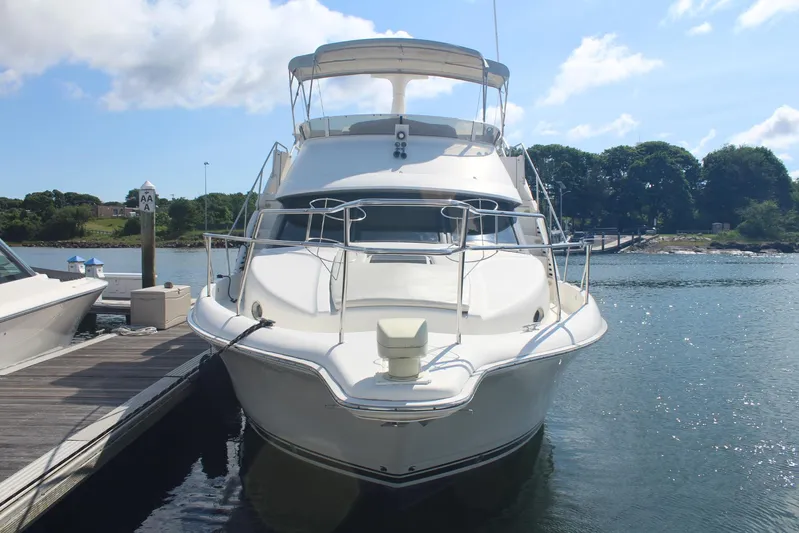 Jet Lag Yacht Photos Pics 2000 Silverton 392 Motor Yacht docked at marina under clear blue sky.