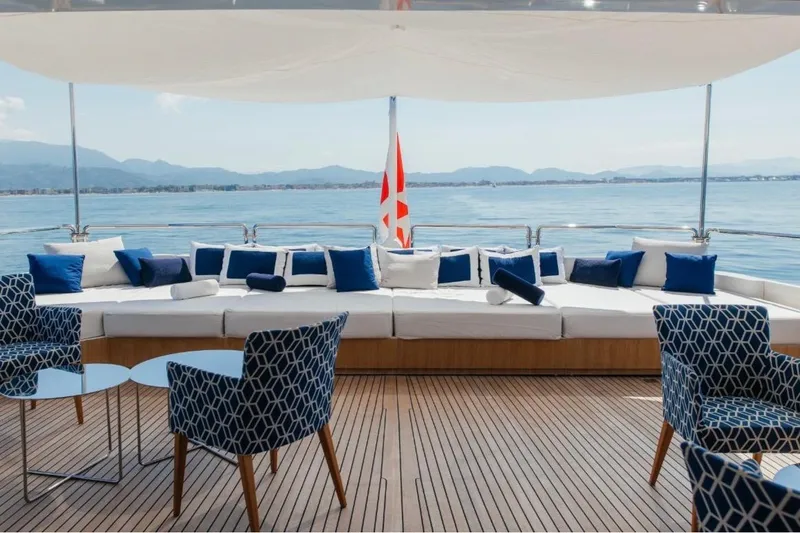 Lady In Blue Yacht Photos Pics Luxurious deck of 1999 Clemna Rossi Navi 135 yacht with elegant seating and ocean view.