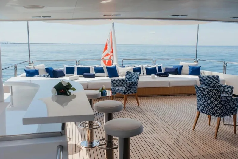 Lady In Blue Yacht Photos Pics Luxurious Clemna Rossi Navi 135 yacht deck with elegant seating, ocean view, and stylish decor.