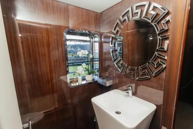 Lady In Blue Yacht Photos Pics Luxurious bathroom on Clemna Rossi Navi 135 yacht, featuring elegant wood paneling and modern fixtures.