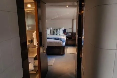 Lady In Blue Yacht Photos Pics Luxurious bedroom interior of 1999 Clemna Rossi Navi 135 yacht, featuring elegant decor and modern amenities.