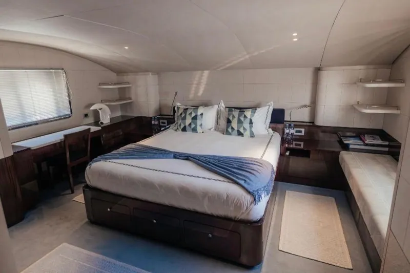 Lady In Blue Yacht Photos Pics Luxurious bedroom interior of 1999 Clemna Rossi Navi 135 yacht with modern furnishings.