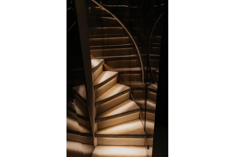 Lady In Blue Yacht Photos Pics Luxurious spiral staircase on Clemna Rossi Navi 135 yacht, 1999 model, with elegant lighting.