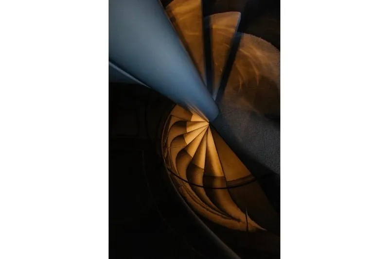 Lady In Blue Yacht Photos Pics Spiral staircase with warm lighting on Clemna Rossi Navi 135 yacht, 1999 model.