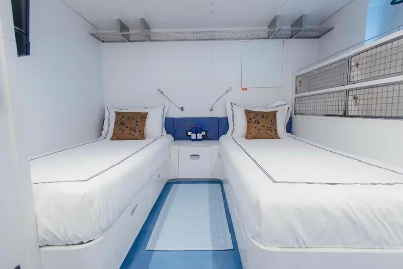 Lady In Blue Yacht Photos Pics Twin cabin interior of 1999 Clemna Rossi Navi 135 yacht, featuring modern white decor.