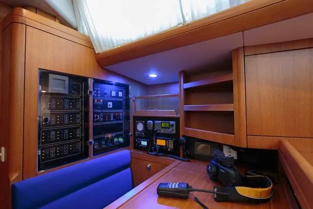 Making Time Yacht Photos Pics Navigation station inside a 2004 Oyster 53 yacht, featuring control panels and communication equipment.