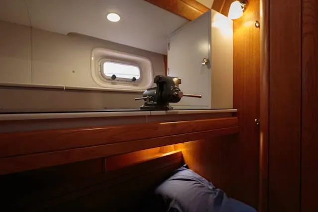 Making Time Yacht Photos Pics Interior of 2004 Oyster 53 yacht with wooden cabinetry and a small window.