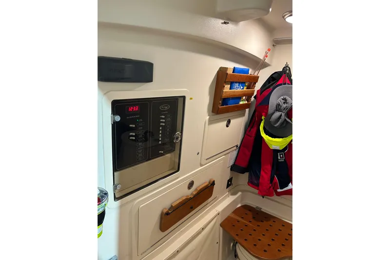  Yacht Photos Pics 2019 Grady-White Canyon 336 cabin interior with control panel and storage.