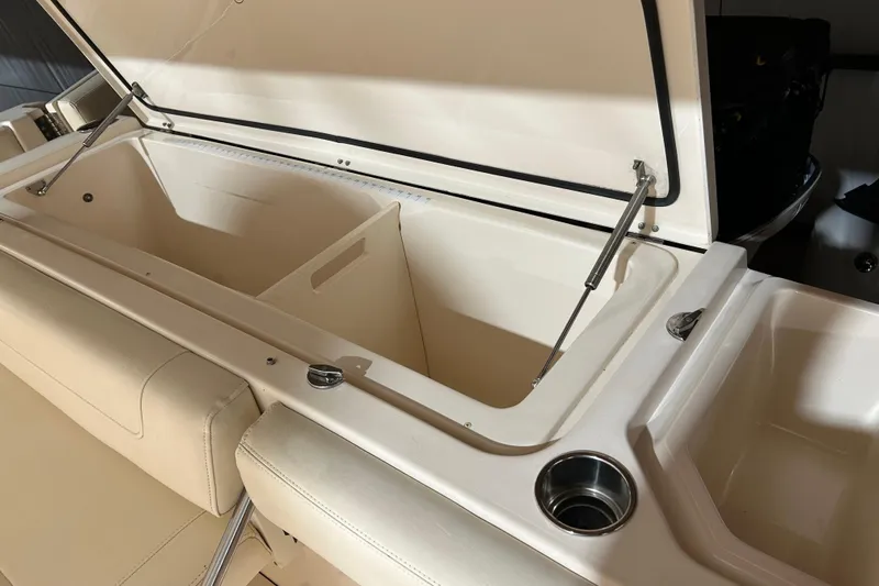  Yacht Photos Pics 2019 Grady-White Canyon 336 boat storage compartment with open lid and cup holder.