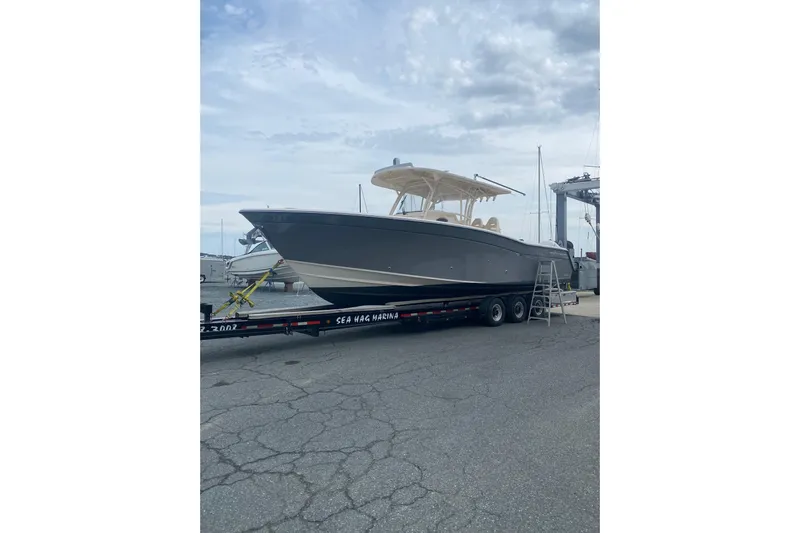  Yacht Photos Pics 2019 Grady-White Canyon 336 boat on trailer at marina, overcast sky.