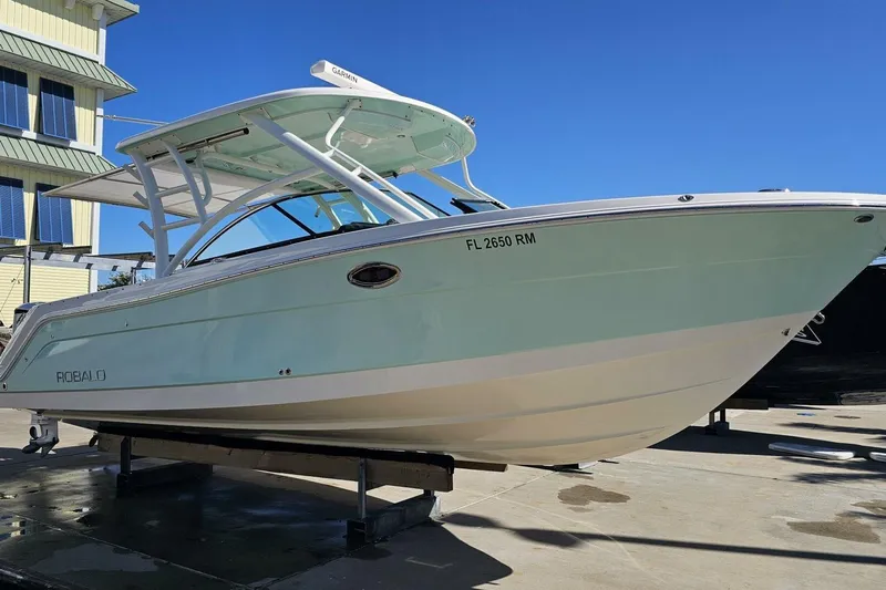  Yacht Photos Pics 2018 Robalo R317 Dual Console boat on display, light blue hull, sunny day.