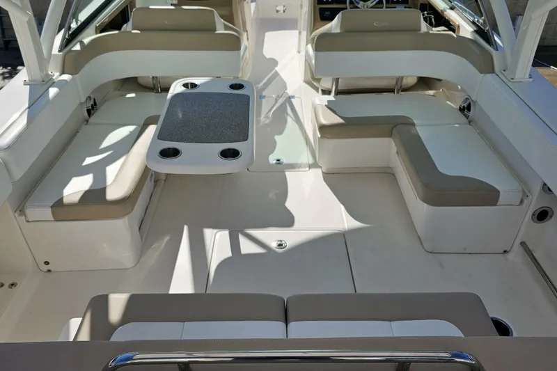  Yacht Photos Pics 2018 Robalo R317 Dual Console boat interior with beige seating and table.