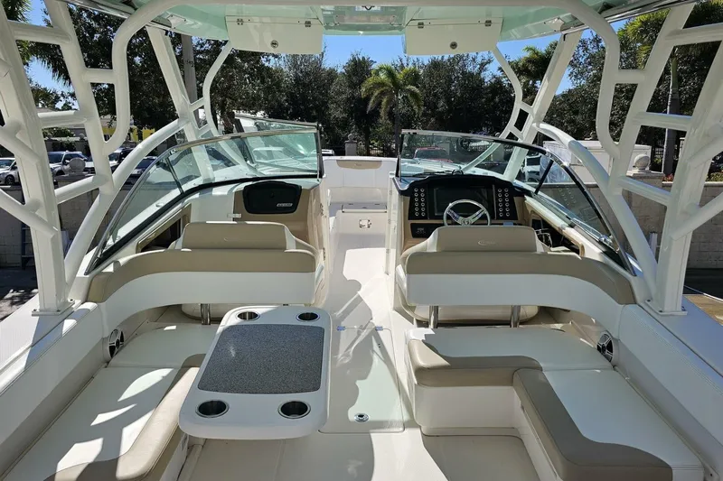  Yacht Photos Pics 2018 Robalo R317 Dual Console boat interior with seating and helm, under sunny skies.