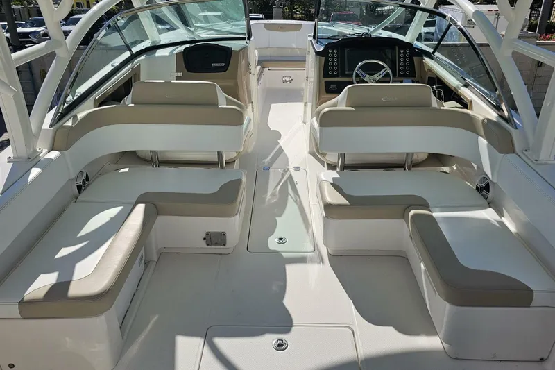  Yacht Photos Pics 2018 Robalo R317 Dual Console boat interior with beige seating and modern dashboard.