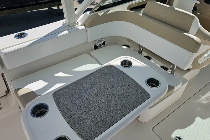  Yacht Photos Pics 2018 Robalo R317 Dual Console interior with beige seating and cup holders.