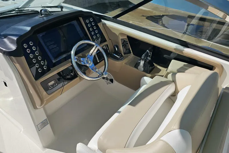  Yacht Photos Pics 2018 Robalo R317 Dual Console boat interior with steering wheel and control panel.