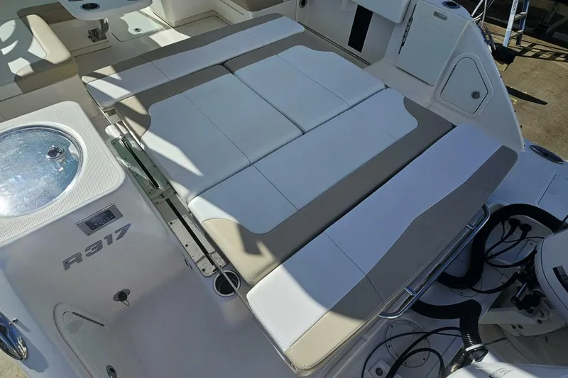  Yacht Photos Pics 2018 Robalo R317 Dual Console boat interior with cushioned seating and livewell.