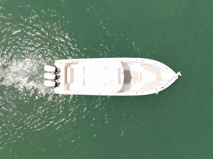  Yacht Photos Pics Aerial view of 2019 Boston Whaler 350 Outrage cruising on green water.
