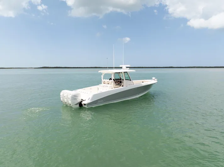  Yacht Photos Pics 2019 Boston Whaler 350 Outrage boat on calm water under a clear sky.