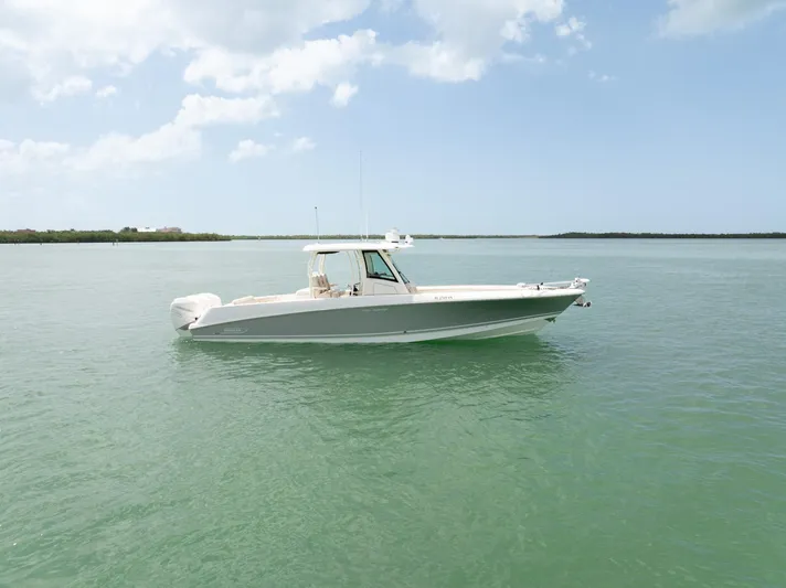  Yacht Photos Pics 2019 Boston Whaler 350 Outrage boat on calm water under a clear sky.