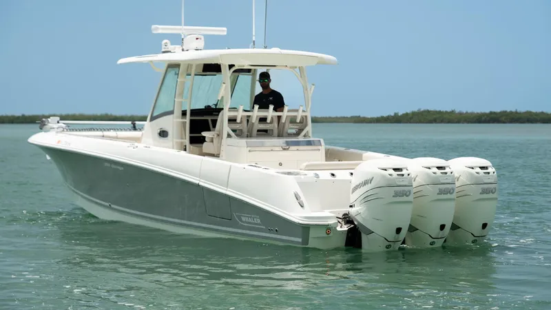  Yacht Photos Pics 2019 Boston Whaler 350 Outrage boat with triple engines on calm water.