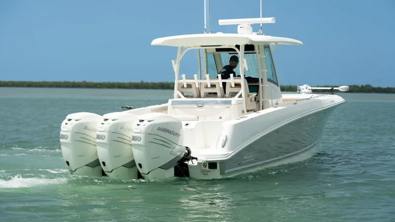  Yacht Photos Pics 2019 Boston Whaler 350 Outrage boat with triple engines cruising on calm water.