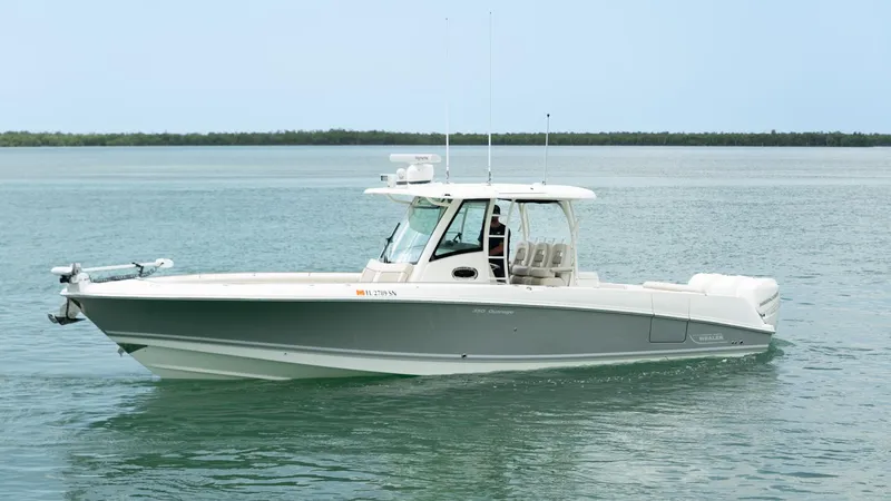  Yacht Photos Pics 2019 Boston Whaler 350 Outrage boat on calm water, side view.