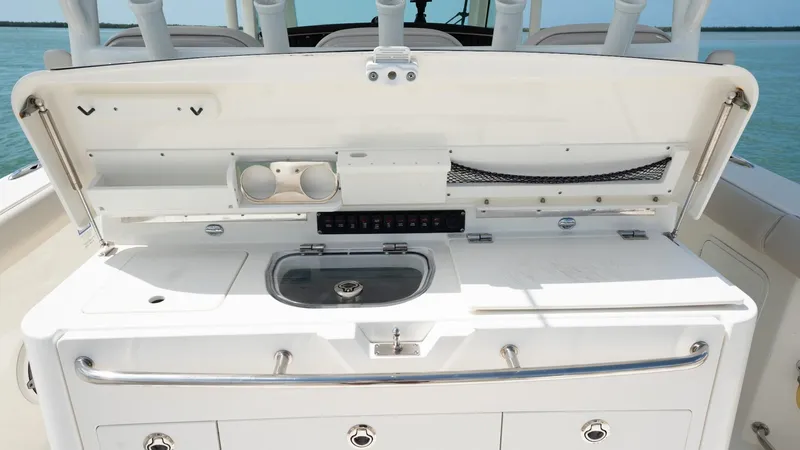  Yacht Photos Pics 2019 Boston Whaler 350 Outrage boat console with storage and sink, open at sea.
