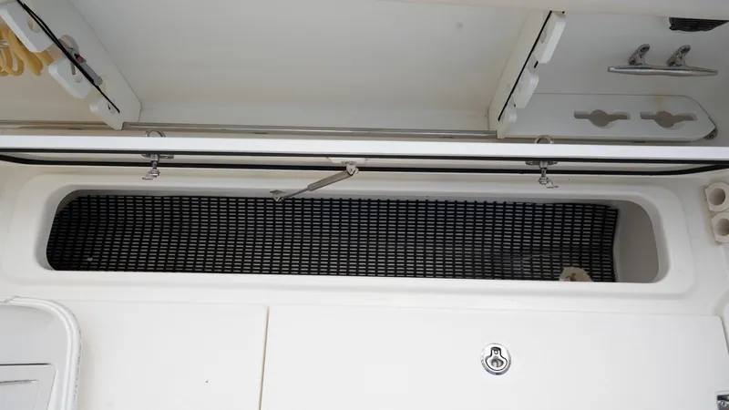  Yacht Photos Pics 2019 Boston Whaler 350 Outrage storage compartment with open hatch and organized interior.